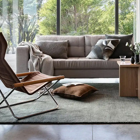 A stylish, forest-green wool floor rug by Baya