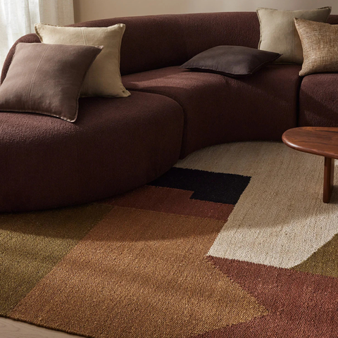 A stylish, muted green wool rug in a contemporary living room