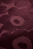 Close up of the Marimekko Unikko floral patterned rug with deep burgundy flowers at varying pile heights