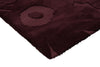 Corner of the Marimekko Unikko floral patterned rug with deep burgundy flowers at varying pile heights