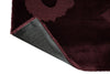 Marimekko Unikko floral patterned rug with deep burgundy flowers with corner folded to show backing
