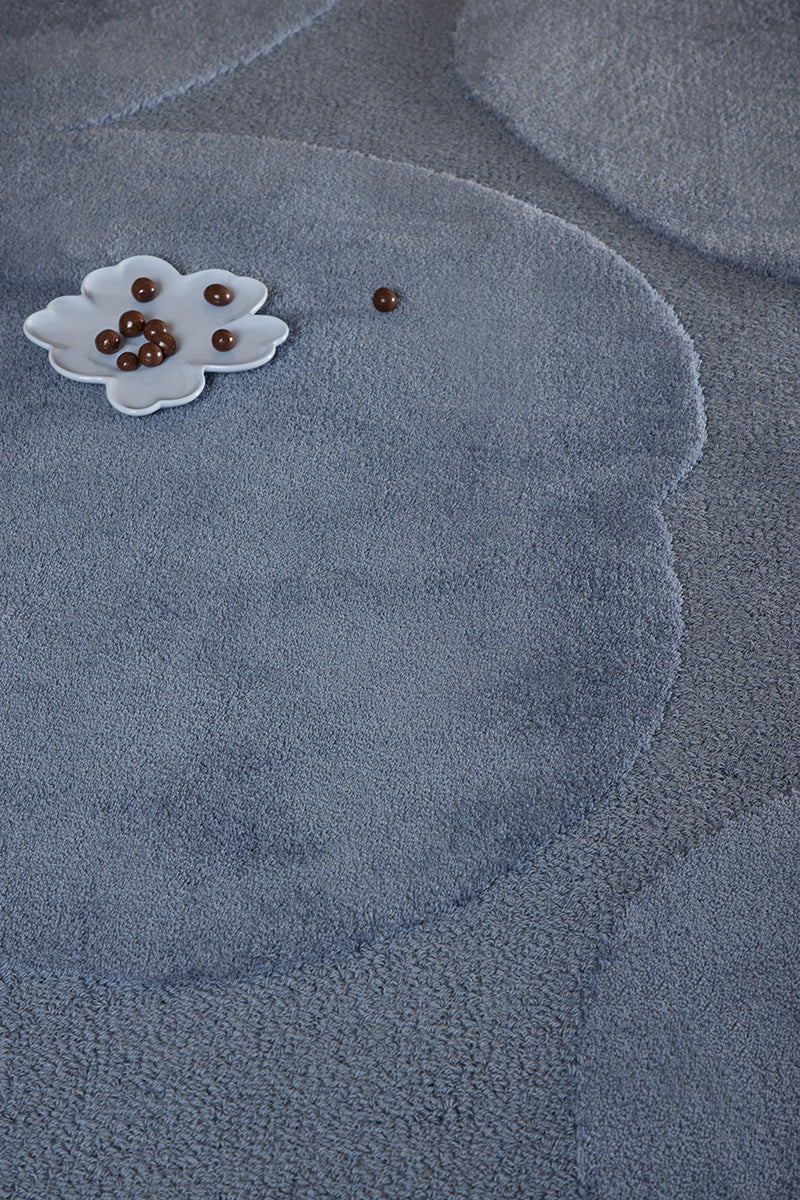 Close up of the Marimekko Unikko floral patterned rug with mid blue flowers at varying pile heights