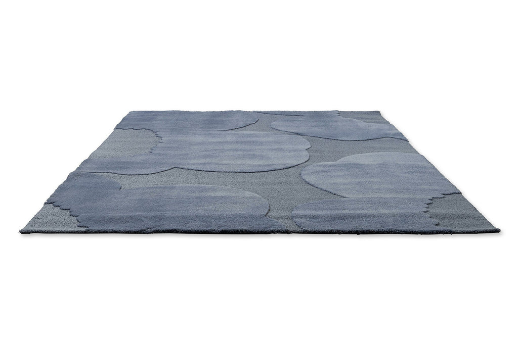 Perspective view of the Marimekko Unikko floral patterned rug with mid blue flowers at varying pile heights