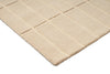 Corner close up of a  Marimekko grid patterned rug in NZ wool and in a neutral creamy white