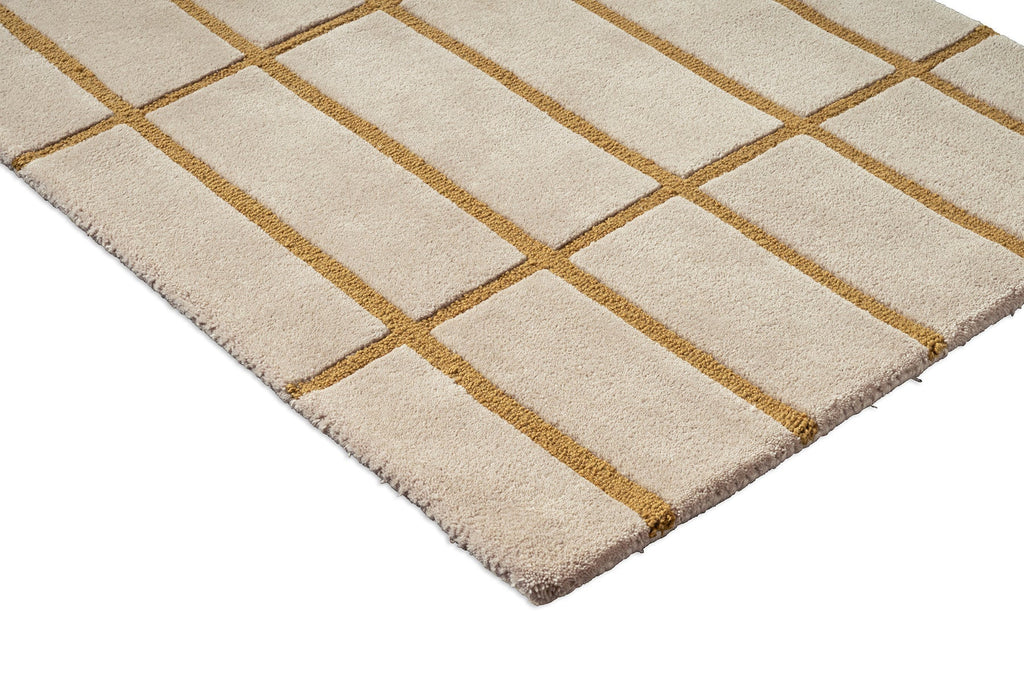 Corner view of a Marimekko NZ wool beige runner rug with gold grid pattern 
