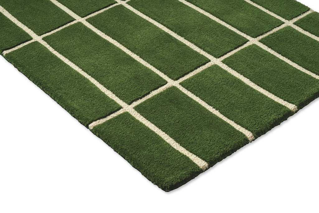Corner view of a green grid-style Marimekko NZ wool runner rug 