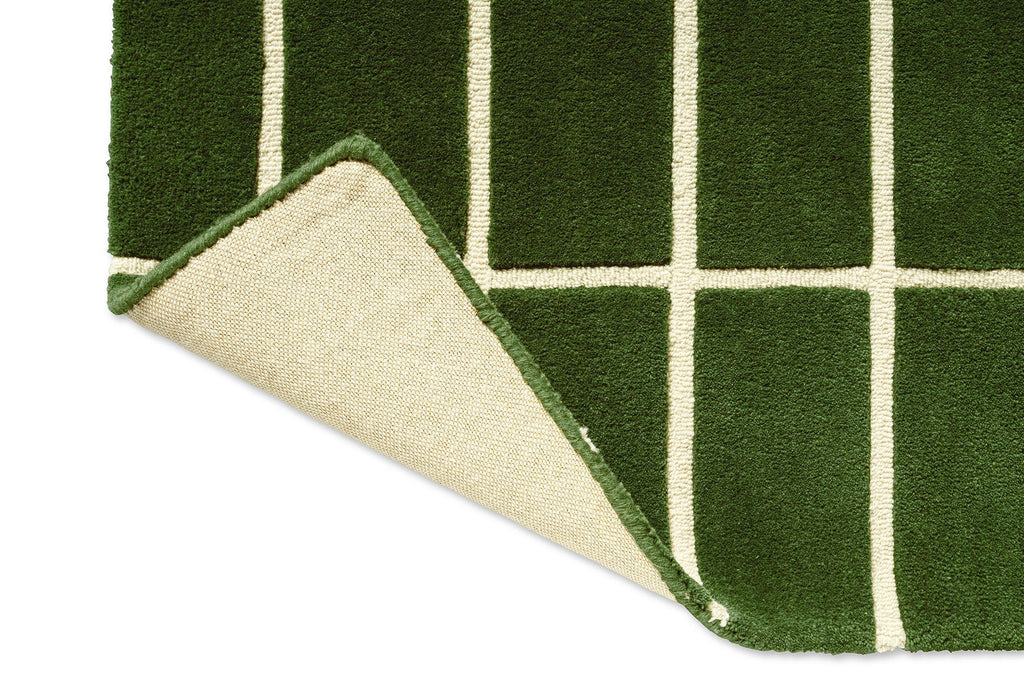 Corner of a green geometric Marimekko NZ wool runner rug showing the backing