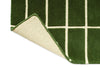 Corner of a green geometric Marimekko NZ wool runner rug showing the backing