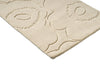 Close up of a Marimekko runner rug in a creamy white with the iconic unikko floral design cut into it