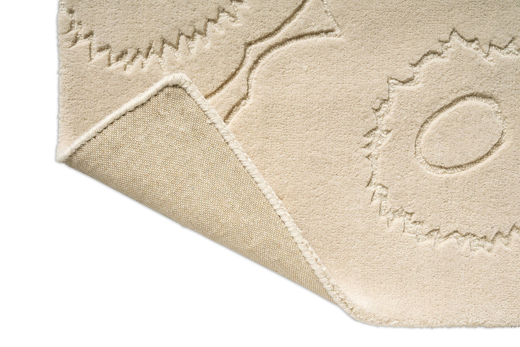 Close up of a Marimekko runner rug in a creamy white with the iconic unikko floral design and showing the backing