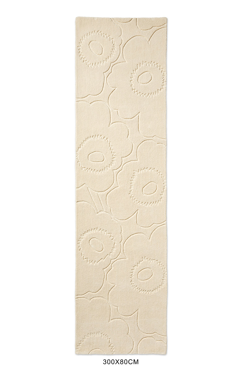 A Marimekko runner rug in a creamy white with a subtle graphic cut into it
