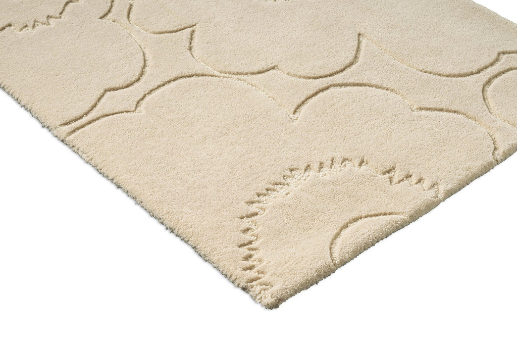 Close up of a Marimekko runner rug in a creamy white with the iconic unikko floral design cut into it