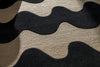Extreme close up of Marimekko NZ wool Rug with black wavy pattern on beige background