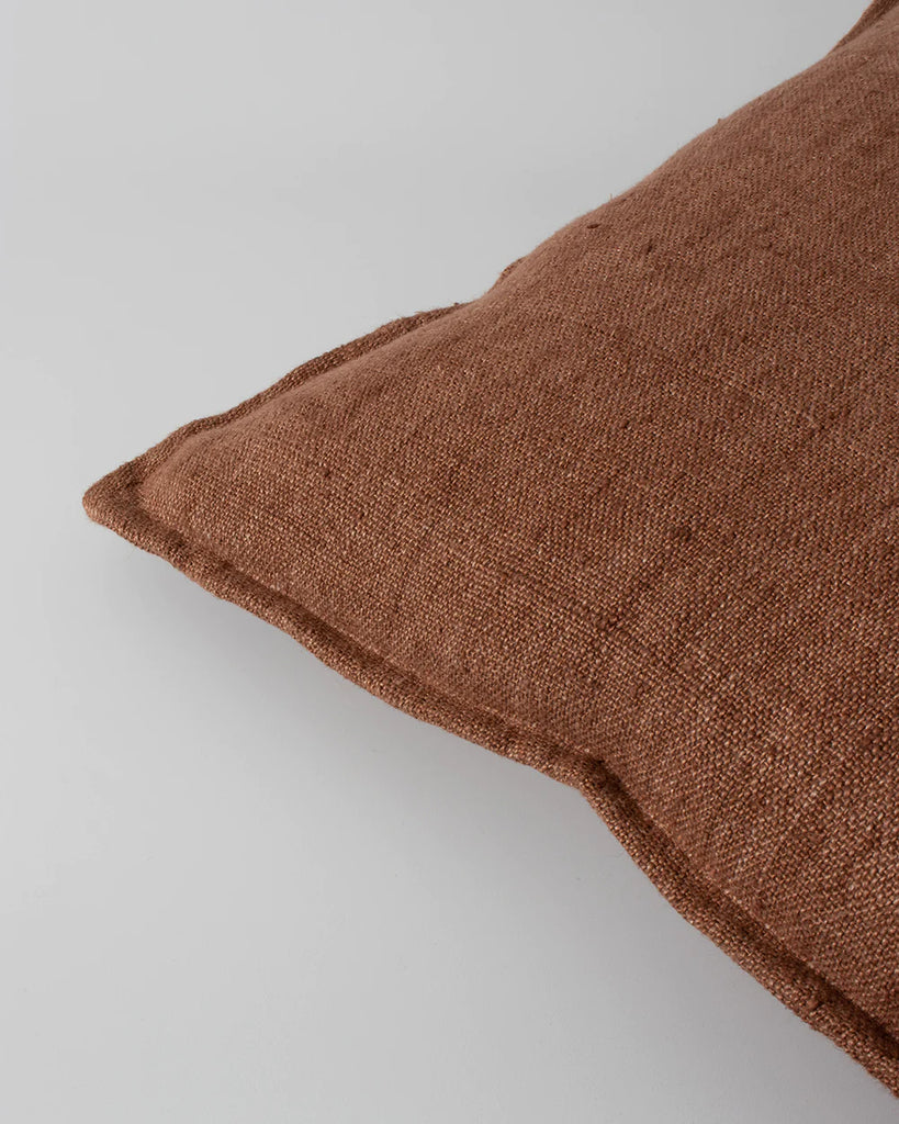 Close up of the textural linen weave of the Baya flaxmill cushion in colour chutney
