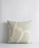 A soft green-grey cushions with painterly interlinking lines on the front