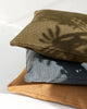 Stack of outdoor cushions by Baya, in green, blue and tan; eco-friendly made from PET recycled plastic bottles.
