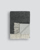 Two-toned charcoal and grey merino throw blanket folded to reveal both sides