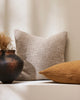 Baya "cyprian'cushion in a neutral pale brown, seen next to Cypriam Caramel