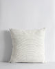 A soft creamy white cushion with a fine black pinstripe