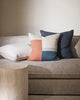 Baya Linen Flaxmill cushion in colour Thunder - a moody blue - next to a patterned cushion