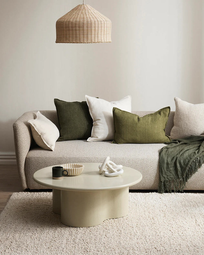 Cream and green cushions, by Baya, arranged on a couch in a contemporary home