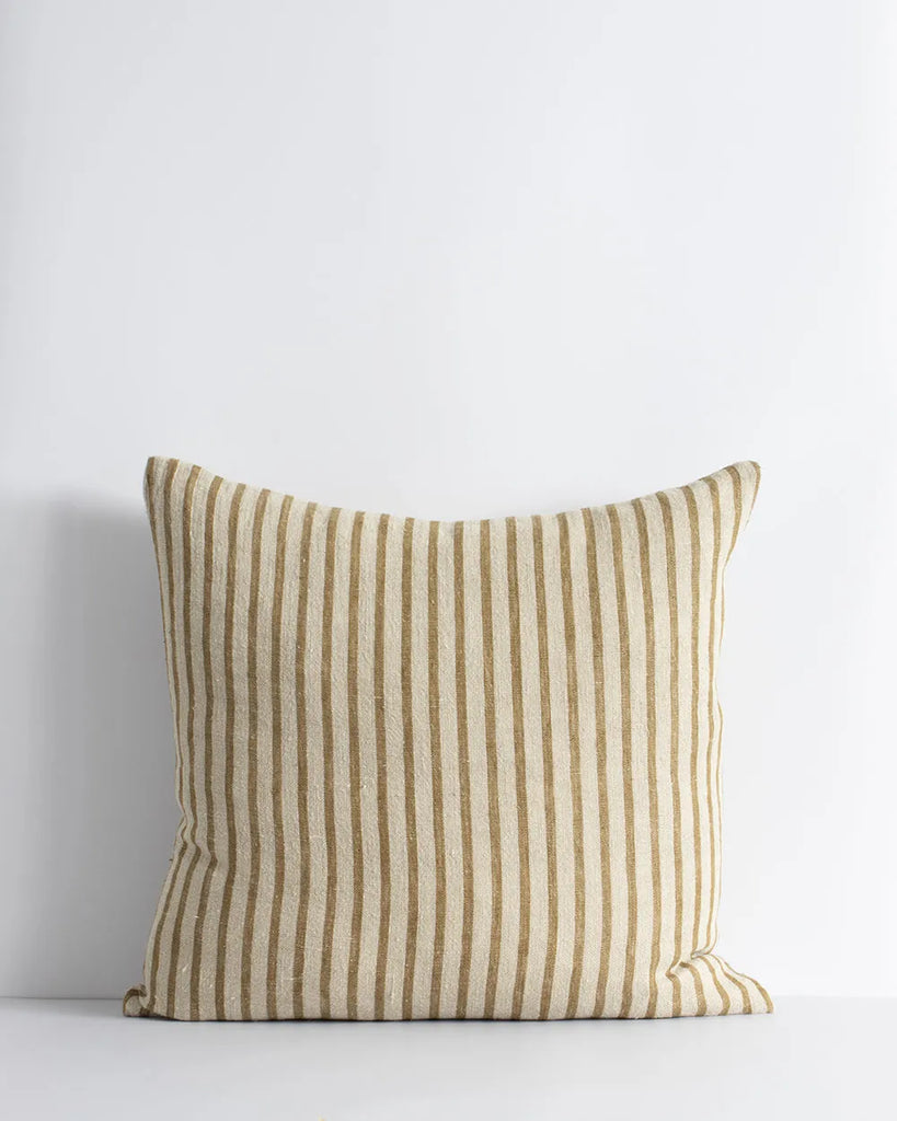 The Baya 'Spencer' linen cushion featuring a natural linen and ochre stripe