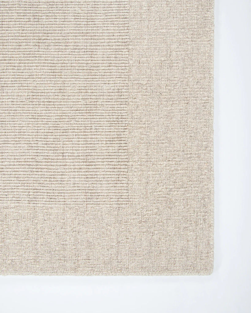 Close up corner shot of the Baya wool rug 'Vermont' in neutral colour 'Sand