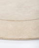 Edge detail of the Baya cream 'Form' curved floor rug
