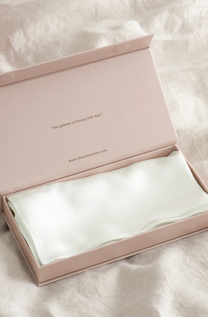 A beautiful silk pillowcase in pearl white, shown in a luxury gift box, by Bianca Lorenne