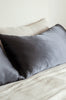 Silk pillowcase in colour slate grey, by Bianca Lorenne, shown on a neutral bed