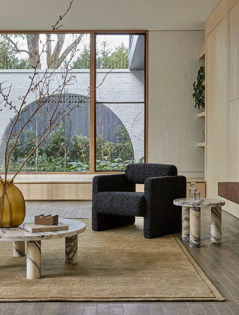 A stylish contemporary living room featuring the Bower Frame 100% wool floor rug in moss green coloour