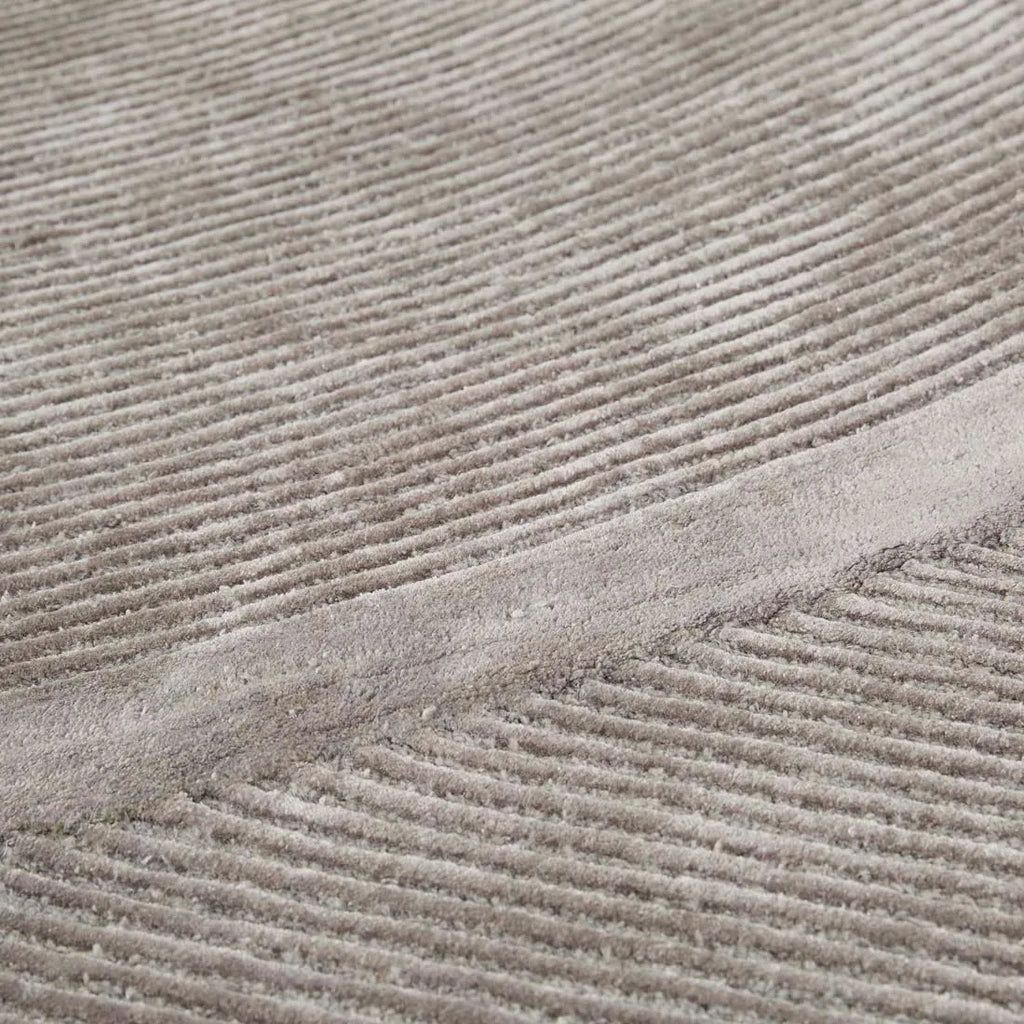 Close up of a grey wool blend floor rug featuring a circular pattern design, by Globe West and Soren Liv nz