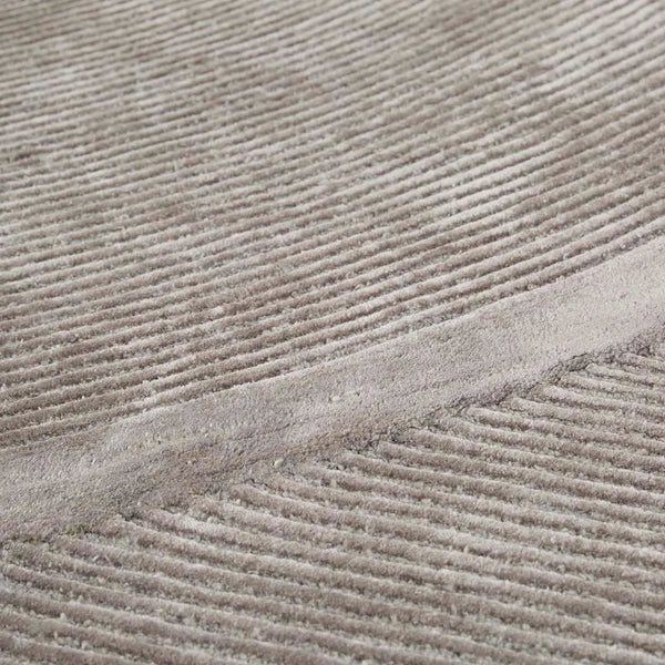 Close up of a grey wool blend floor rug featuring a circular pattern design, by Globe West and Soren Liv nz