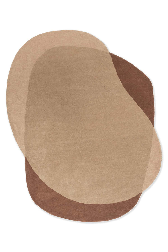 Full view from above of an organically shaped handtufted wool rug in caramel and warm brown tones by Brink and Campman