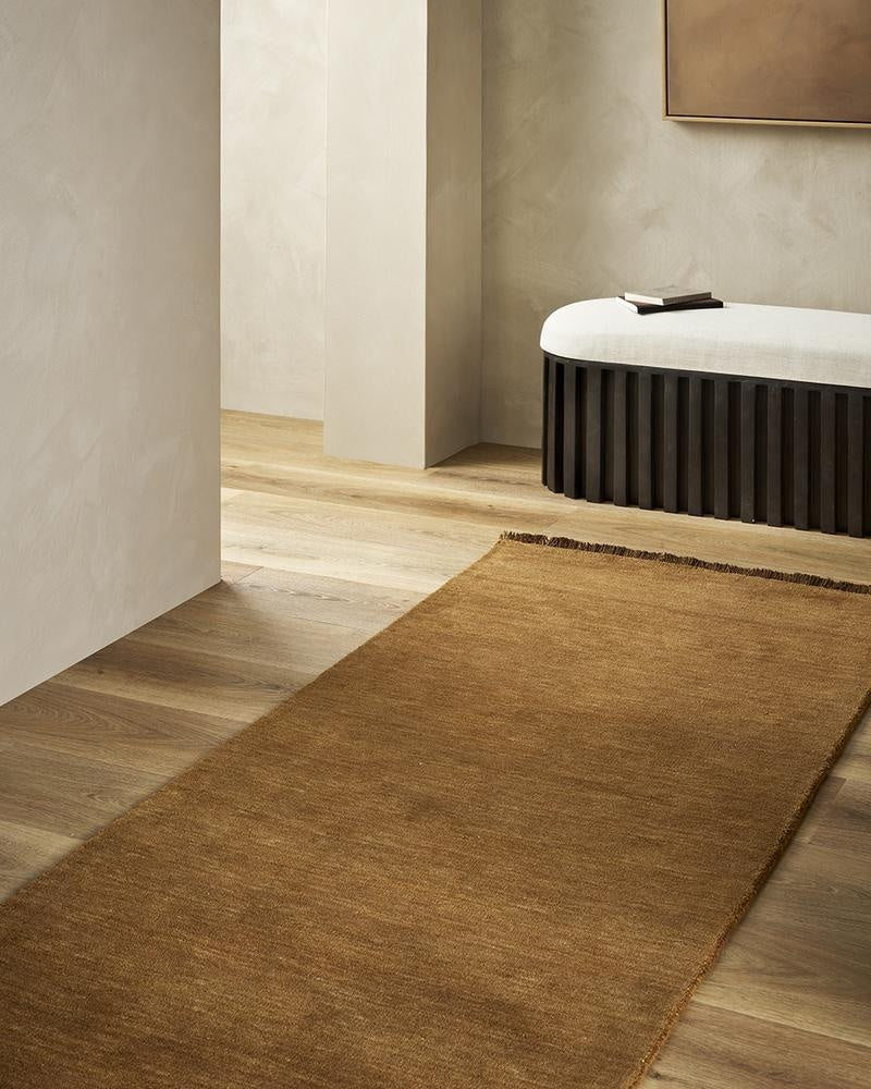 The Baya Sandringham pure wool floor runner rug in Pecan rich brown, seen in a modern home.
