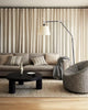 A modern living room inneutral colours, featuring weave home cushions and throw blanket