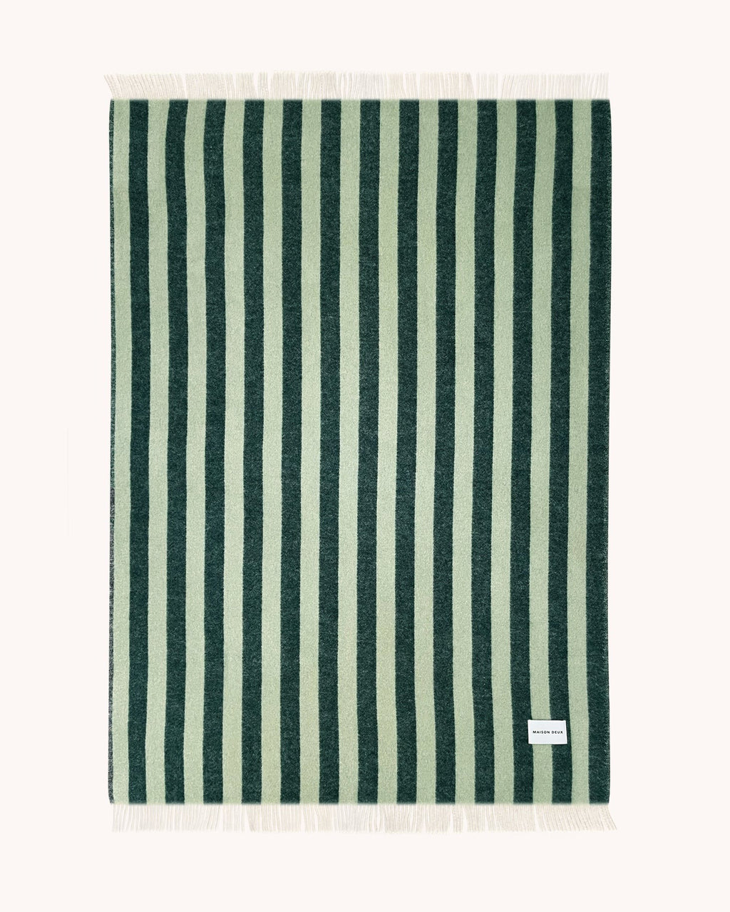 A full view of the Maison Deux Candy Stripe throw blanket, made from NZ wool, in shades of forest green and sage. 