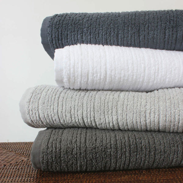 Soft bath towel range in modern colours, stacked 
