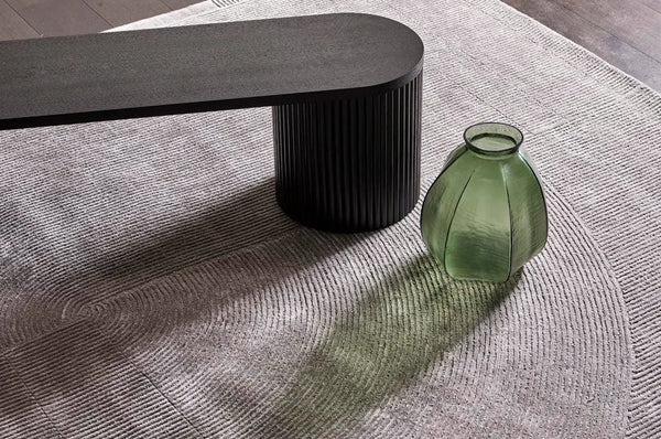 A grey wool blend floor rug featuring a circular pattern design, by Globe West and Soren Liv nz