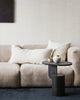A chic interior scene featuring a cream coloured couch and two artisanal milk and midnight striped cushions by Baya NZ.  