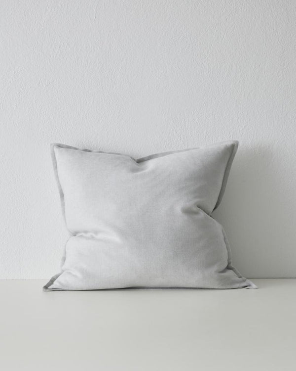 The Weave Home Fiore cushion in colour 'Glacier' - a pale blue-grey - with flange edge.