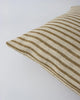 Close up of the Baya 'Spencer' linen cushion featuring a natural linen and ochre stripe