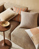 Warm brown and beige toned cushions by Weave Home nz on a couch in a modern living room
