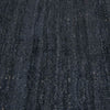 Close up of the weave of a dark blue wool blend floor rug