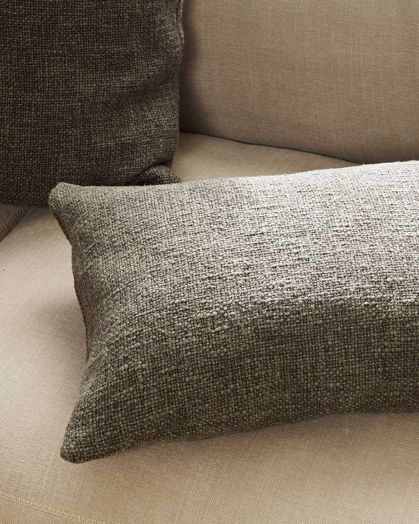 A lumbar cushion in shades of warm, deep green, in a very soft textural weave, by Baya. 