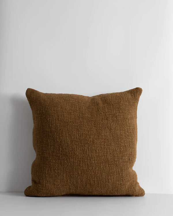 A rich brown cushion in a textural weave by Baya