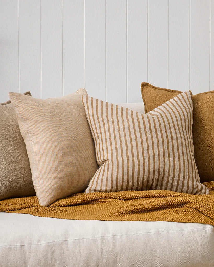 Complementary ochre-toned cushions by Baya