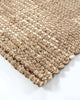 Corner view of the Baya jute rug, showing its beautiful textural weave