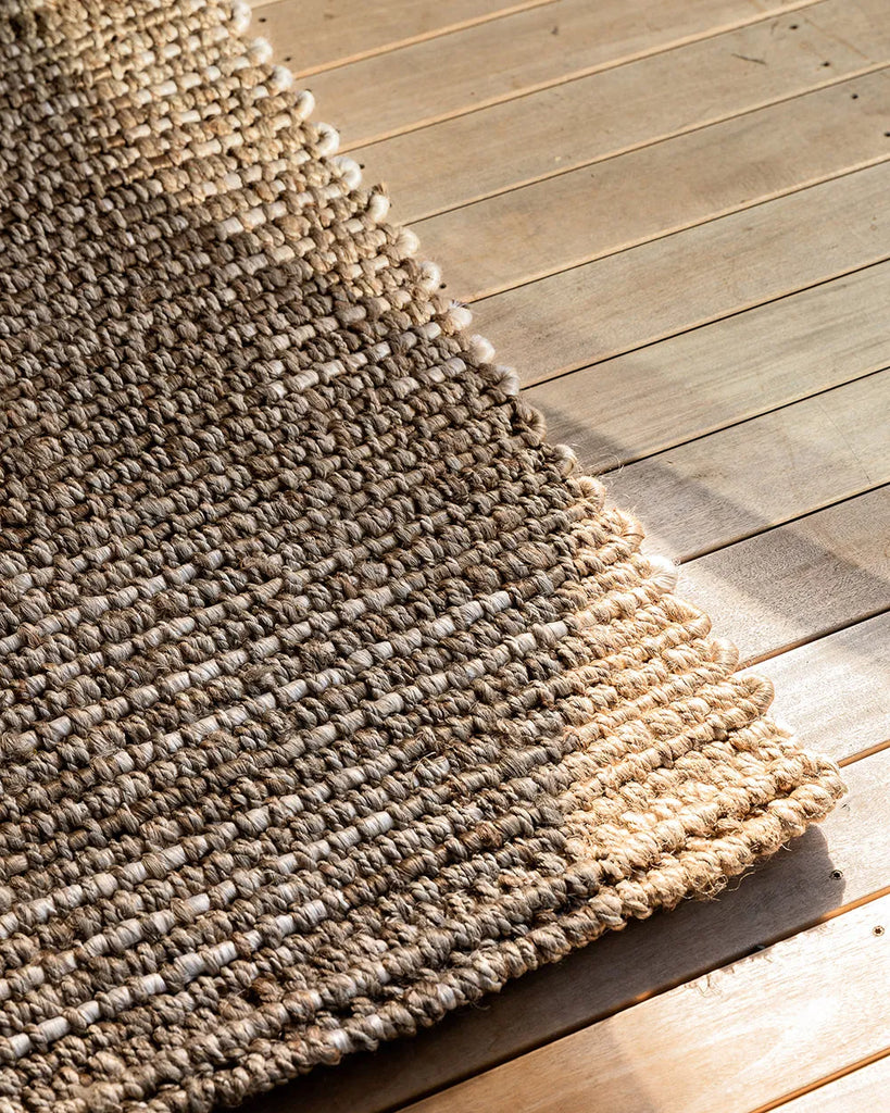 View of the Portsea entrance door mat set against wooden floorboards in a contemporary home
