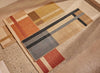 Èlitis Geometric patterned handbraided jute rugs in three colourways on a textured floor